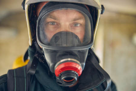 Close up portrait of face of firefighter posing at the photo cameraの写真素材