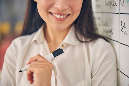Kind brunette female person expressing positivity while looking straight at cameraの写真素材