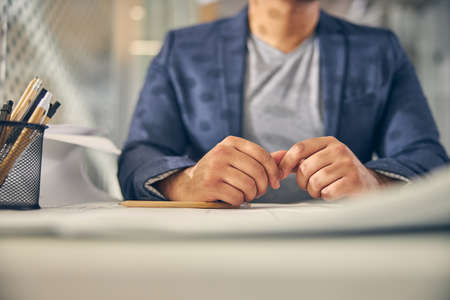 Kind international architecture holding hands together on the table and waiting for the conferenceの写真素材