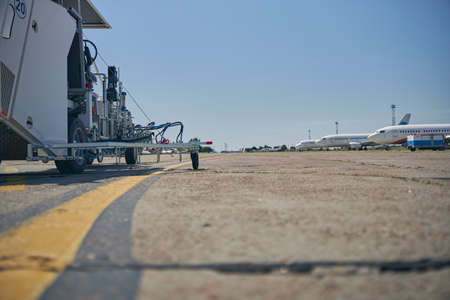 Line of planes standing on the background, being ready for next flights