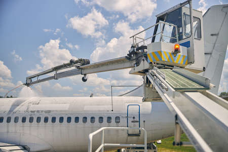 Professional unit being outside while preparing airplane for flight, washing wings