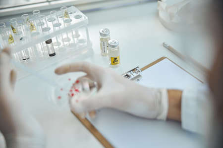 Cropped photo of a Caucasian scientist working on a coronavirus vaccine in a research lab