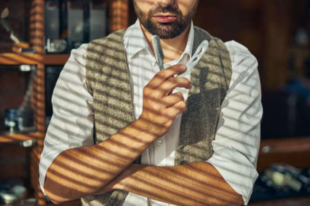Cropped photo of a professional barber looking dapper and holding a cut-throat razor at his hair salonの写真素材