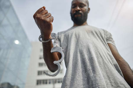 Close up of male hand being handcuffed, taking part in the protest against racism