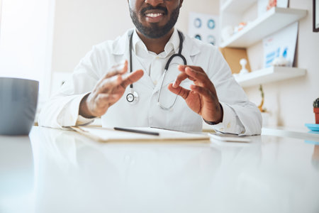 General practitioner making a circle with his fingers while encouraging a person before himの写真素材