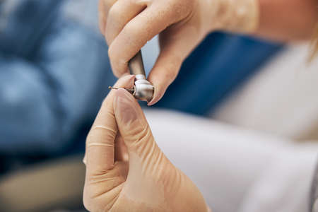 Professional dentist wearing rubber gloves while going to do teeth treatmentの写真素材