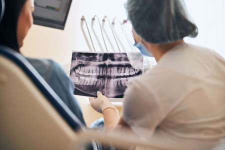 Close up of young woman that visiting stomatology, doing checkup of her teethの写真素材