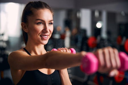 Focused photo on sportswoman keeping her body fitの写真素材