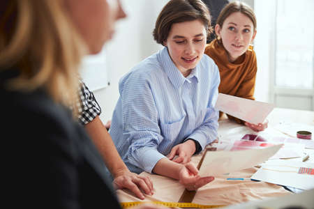 Admiring the drawings of colleagues while working on designの写真素材