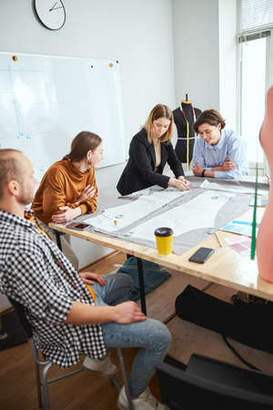 Positive friendly designers and tailors working together