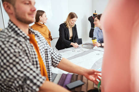 Positive friendly designers and tailors working together