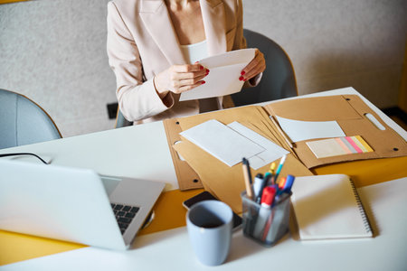Close up of attentive woman reading notesの写真素材