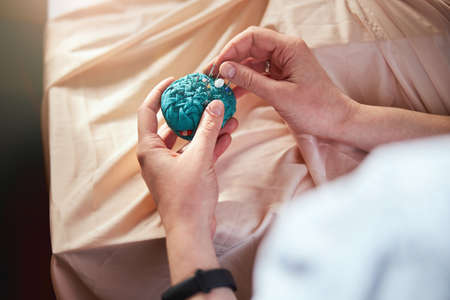 Clothes designer taking a needle from pincushion