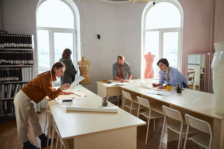 Group of dress designers involved in clothes creationの写真素材