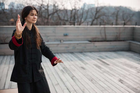 Woman martial artist moving hand to position