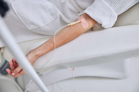 Woman hand on medical armchair on the medicine armchair with syringe vitamin in beauty center