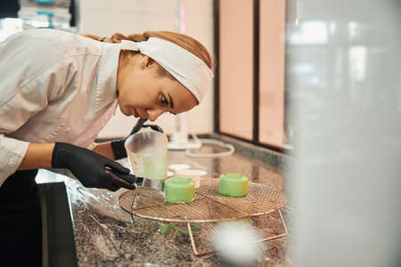 Dedicated pastry chef working on creating perfect dessertの写真素材