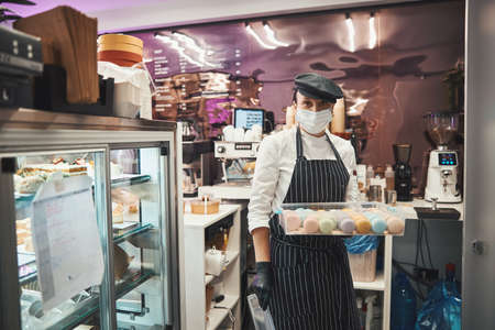 Mindful chef following safety protocols while working at cafeの写真素材