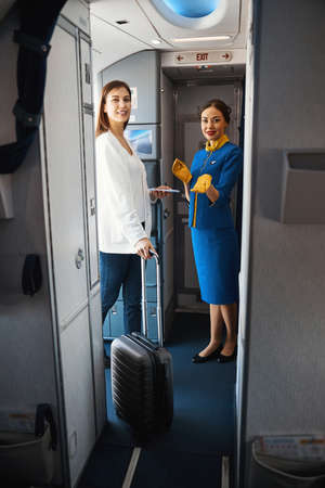 Friendly women looking ready for the international flightの写真素材