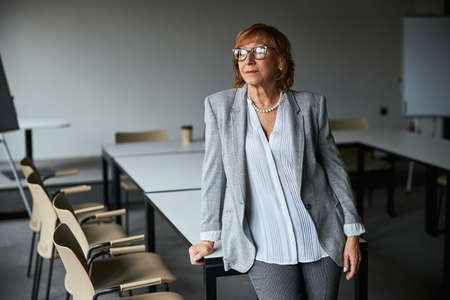Positive delighted brunette looking aside at windowの写真素材