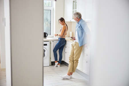 Sincere young woman standing in the kitchen
