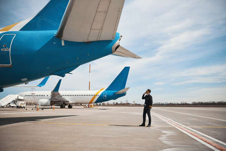 Pilot checking rear part of plane before flight