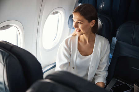 Pretty lady enjoying the view from the porthole
