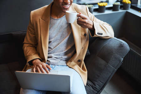 Close up of kind freelancer enjoying aroma coffee