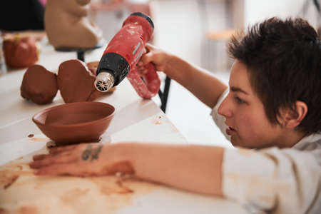 Portrait of kind master drying clay bowlの写真素材