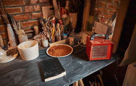 Inside interior of creative studio with elements of pottery and tools for decorationの写真素材