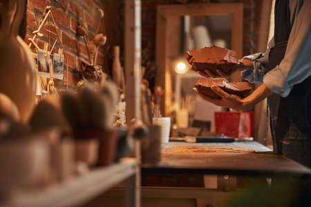 Image of delicate process modeling of earthenware product in pottery workshop