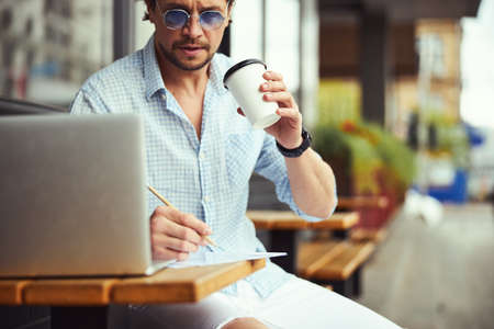 Close up of handsome male enjoying his coffeeの写真素材
