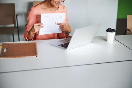 Charming elegant female internet marketing specialist is acting negotiation online