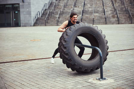 Young healthy male person demonstrating his strengthの写真素材