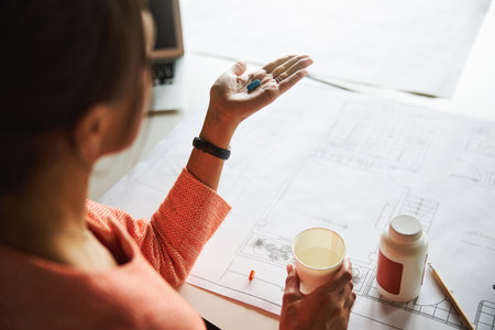Charming elegant woman office worker with vitamin in hand in working placeの写真素材