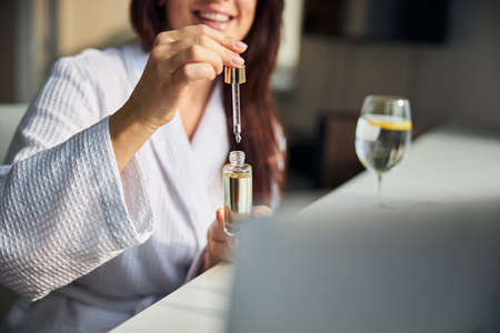 Cheerful longhaired woman taking care of her skinの写真素材