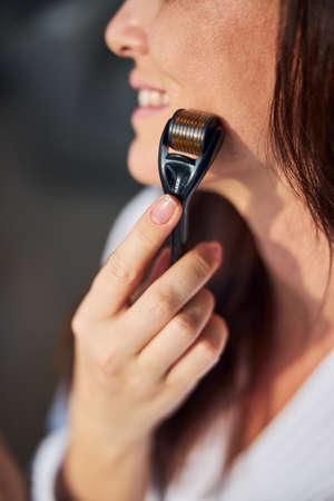 Focused photo on woman doing face massage