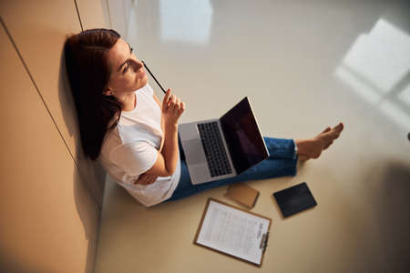 Cute brunette female person having distance studying