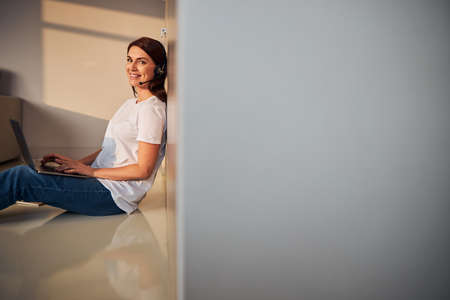 Positive delighted female person working on distance