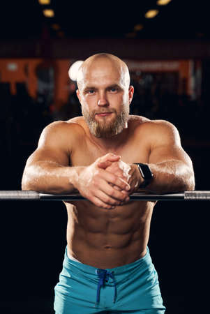 Muscular male athlete posing at the gymの写真素材