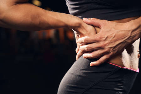 Sportswoman being troubled by back muscle sorenessの写真素材