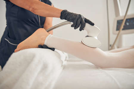 Using special device for reducing fat on legsの写真素材