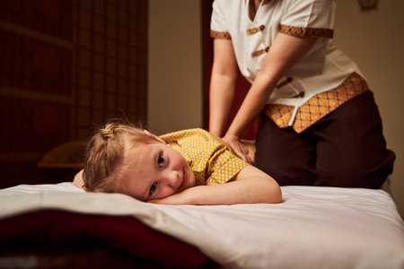 Happy girl relaxing from herapeutic rubdown on coachの写真素材