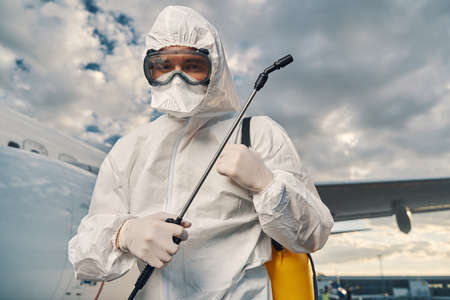 Airport worker dressed in protective gear looking aheadの写真素材