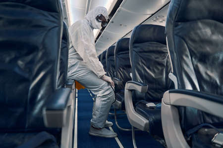 Tired man resting after the antiviral interior disinfectionの写真素材