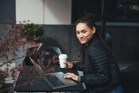 Confident young specialist working outdoors and smiling