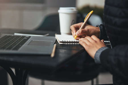 Paying attention to the detail and writing everything downの写真素材
