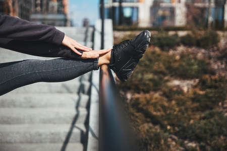 Flexible athlete doing a stretching exercise in a standing positionの写真素材