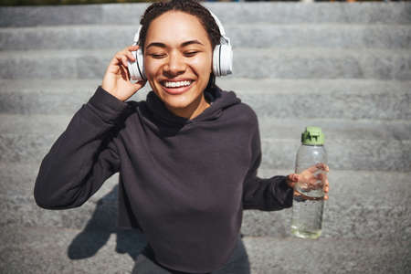 Young female grooving on her favorite musicの写真素材