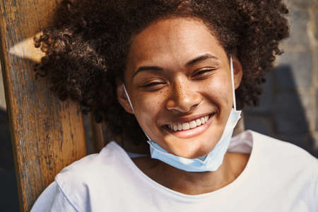 Portrait of cute lady relaxing outdoors in sunny weatherの写真素材